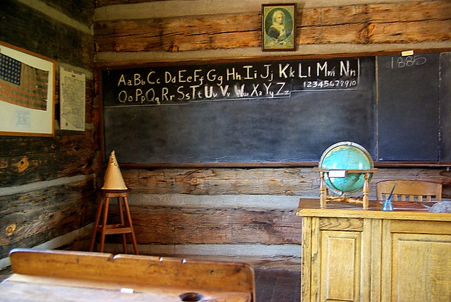 historic school room with dunce hat and world globe