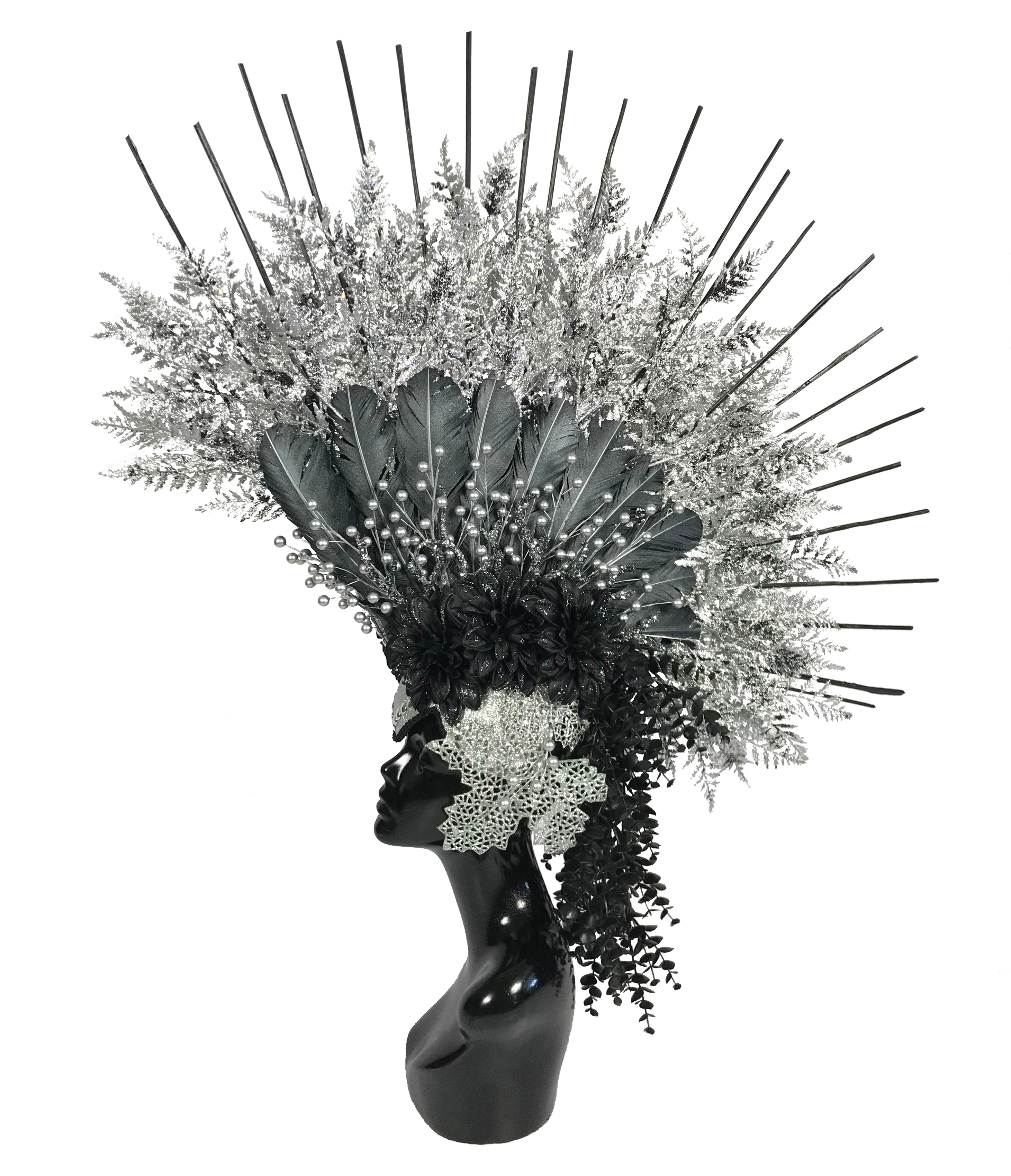 Black and silver headdress made by Anja Yamaji, displayed on a mannequin head. This design showcases what can be created on top of a warrior style headdress base.