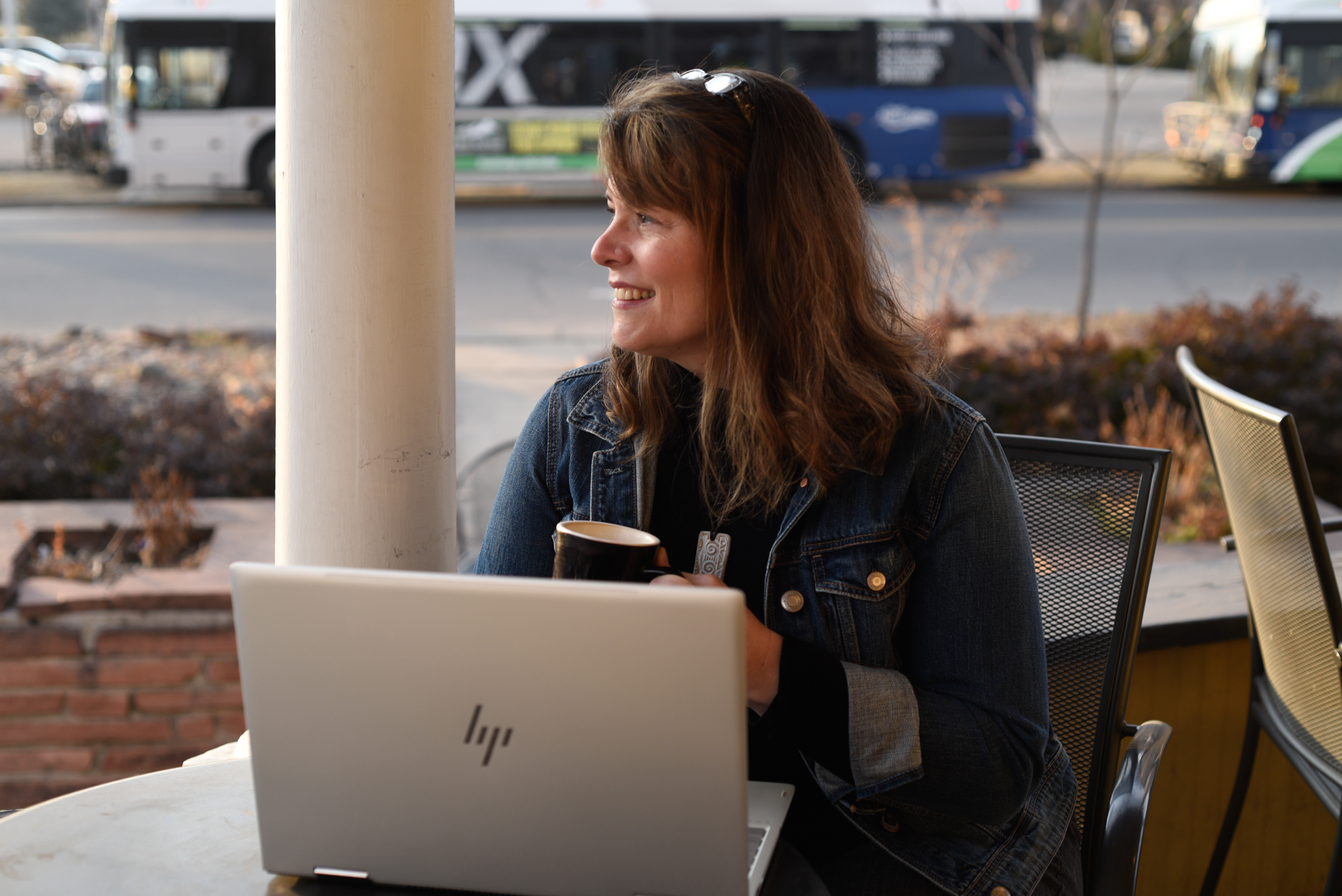 Crushing it on LinkedIn biography image of woman at table with laptop