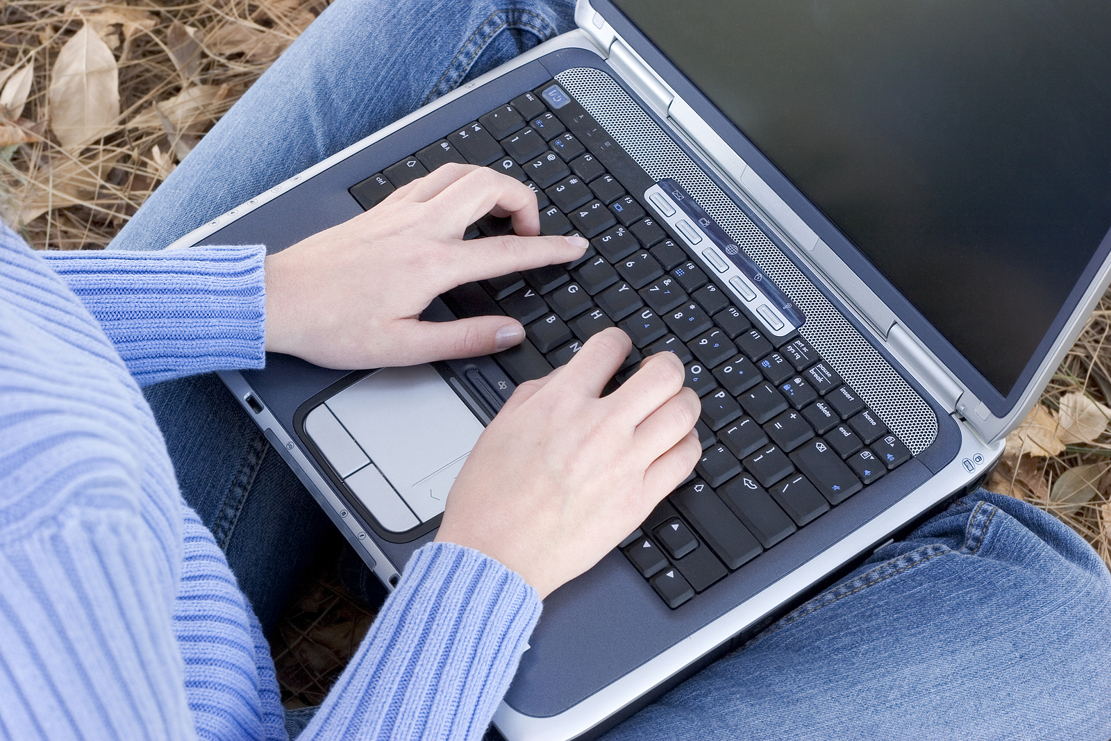 Photo of a therapist working on their website SEO on a laptop computer.