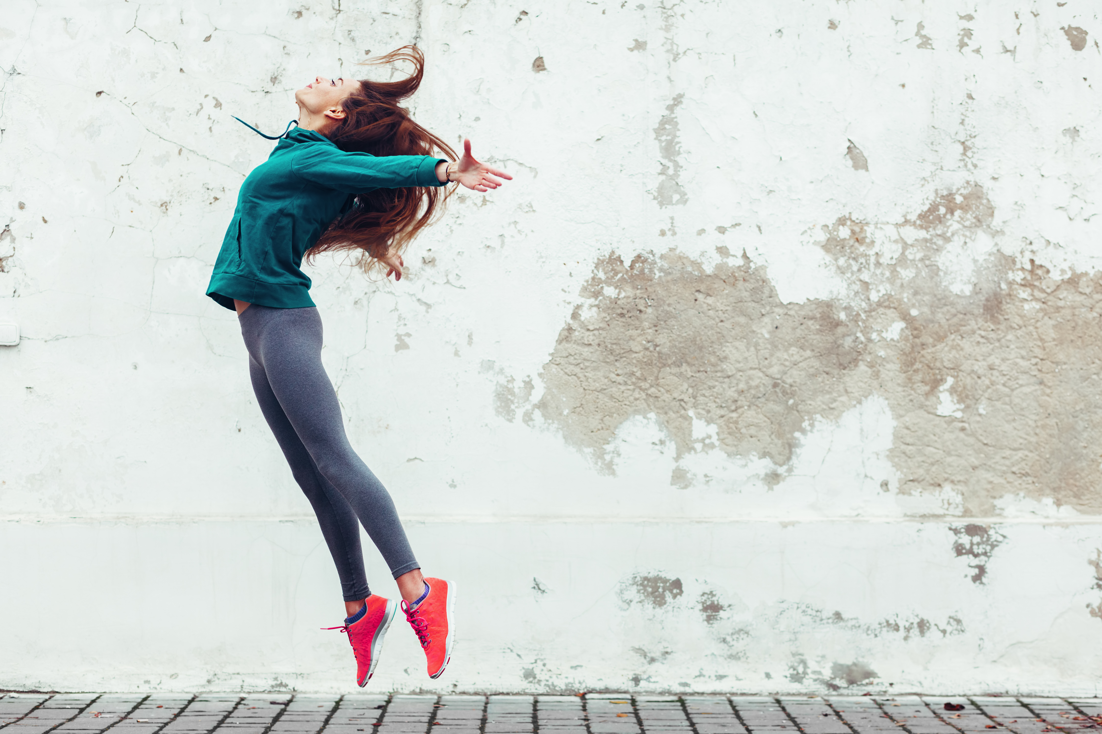 woman in sports clothes jumping