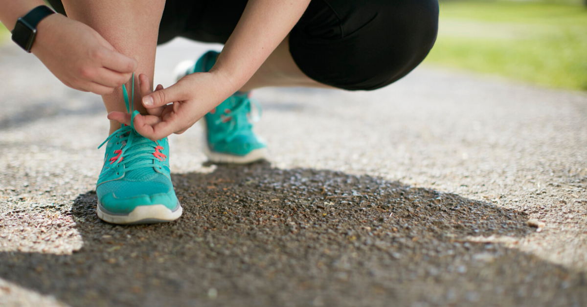 Person tying up shoelaces ready to start running. Get ready for action. Discover how to get in front of your dream clients and wow them into working with you.
