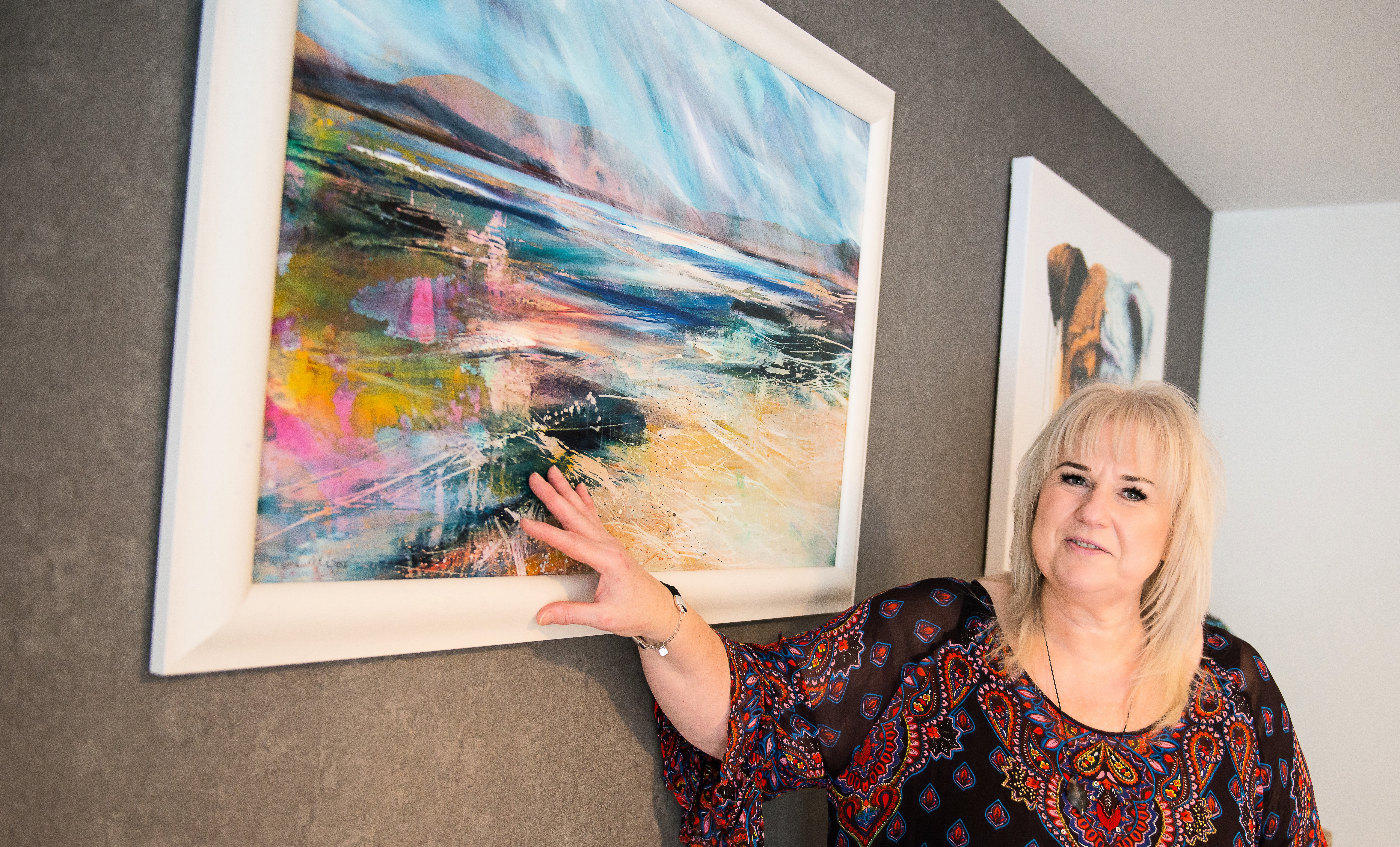 picture of a woman touching a painting