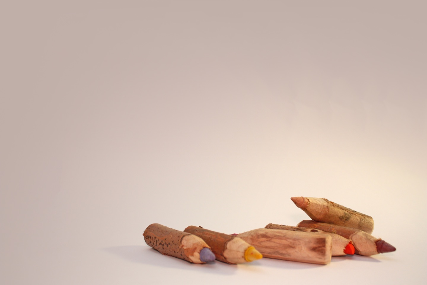 picture of 6 small coloured pencils with a white background 