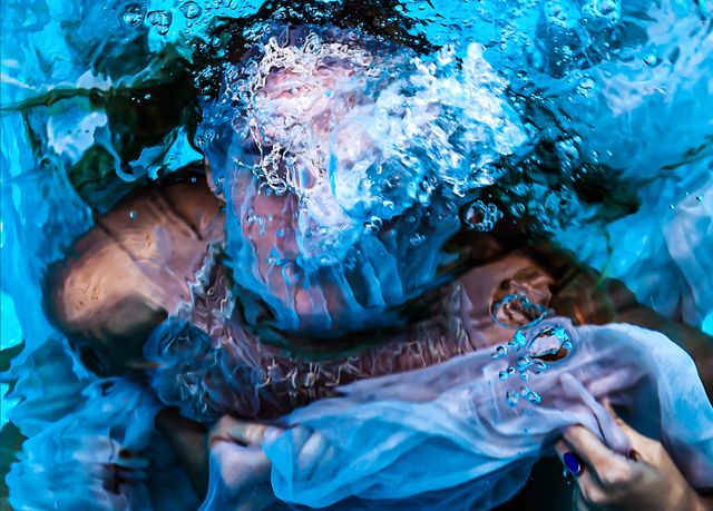 image: Title: Rise Medium: Fine art photography and hand-stitched adornments by the artist. 