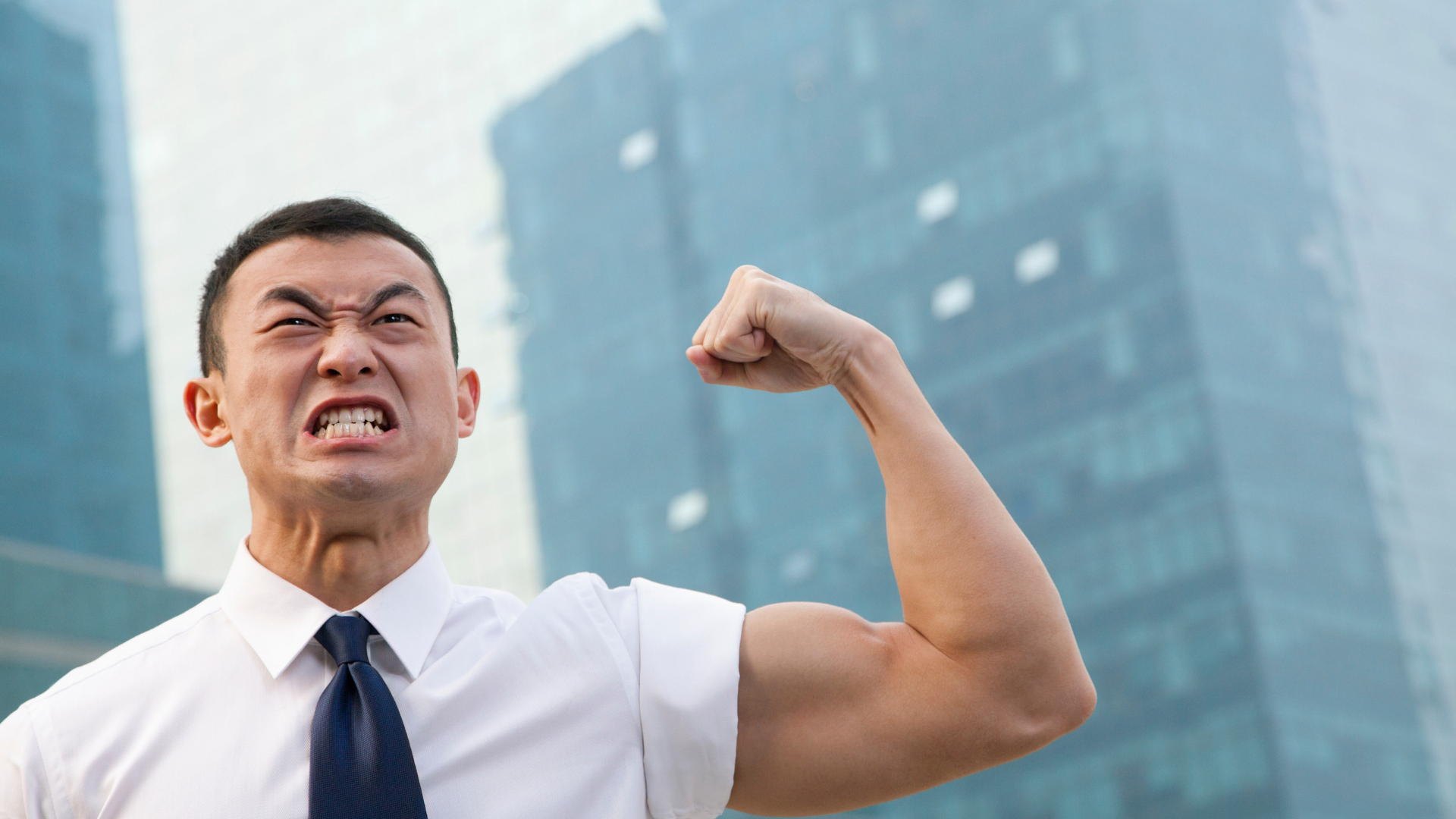 Businessman flexing