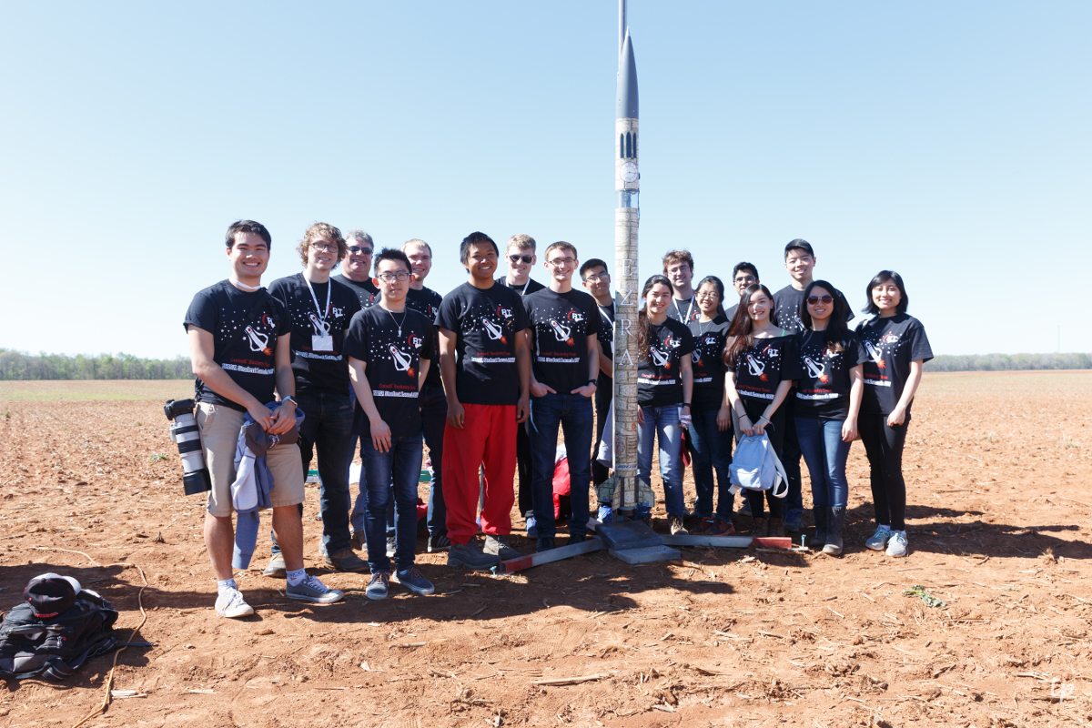 Cornell Rocketry Team poses with their rocket, Ezra.