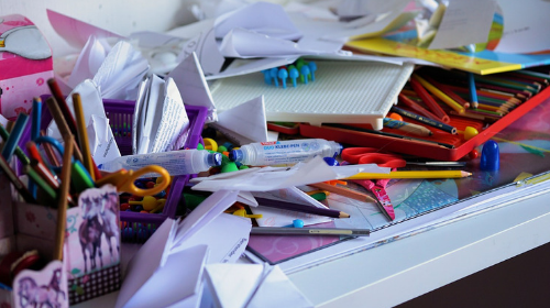 A messy desk that needs to be organized