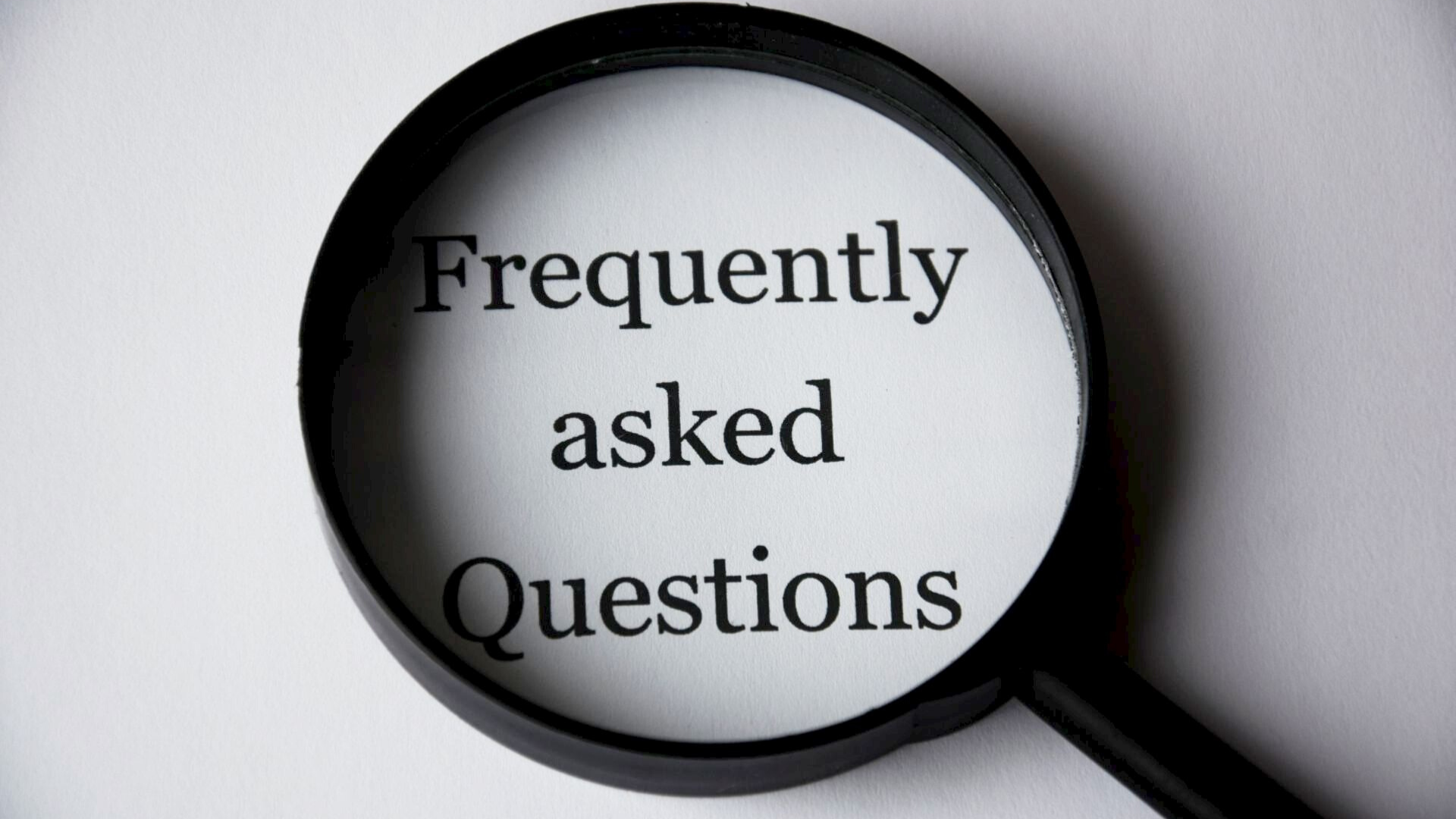 alt=&quot;giant magnifying glass over the words &quot;frequently asked questions&quot;