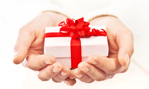 alt=&quot;hands coming out of a white background, holding a white gift with a red bow&quot;