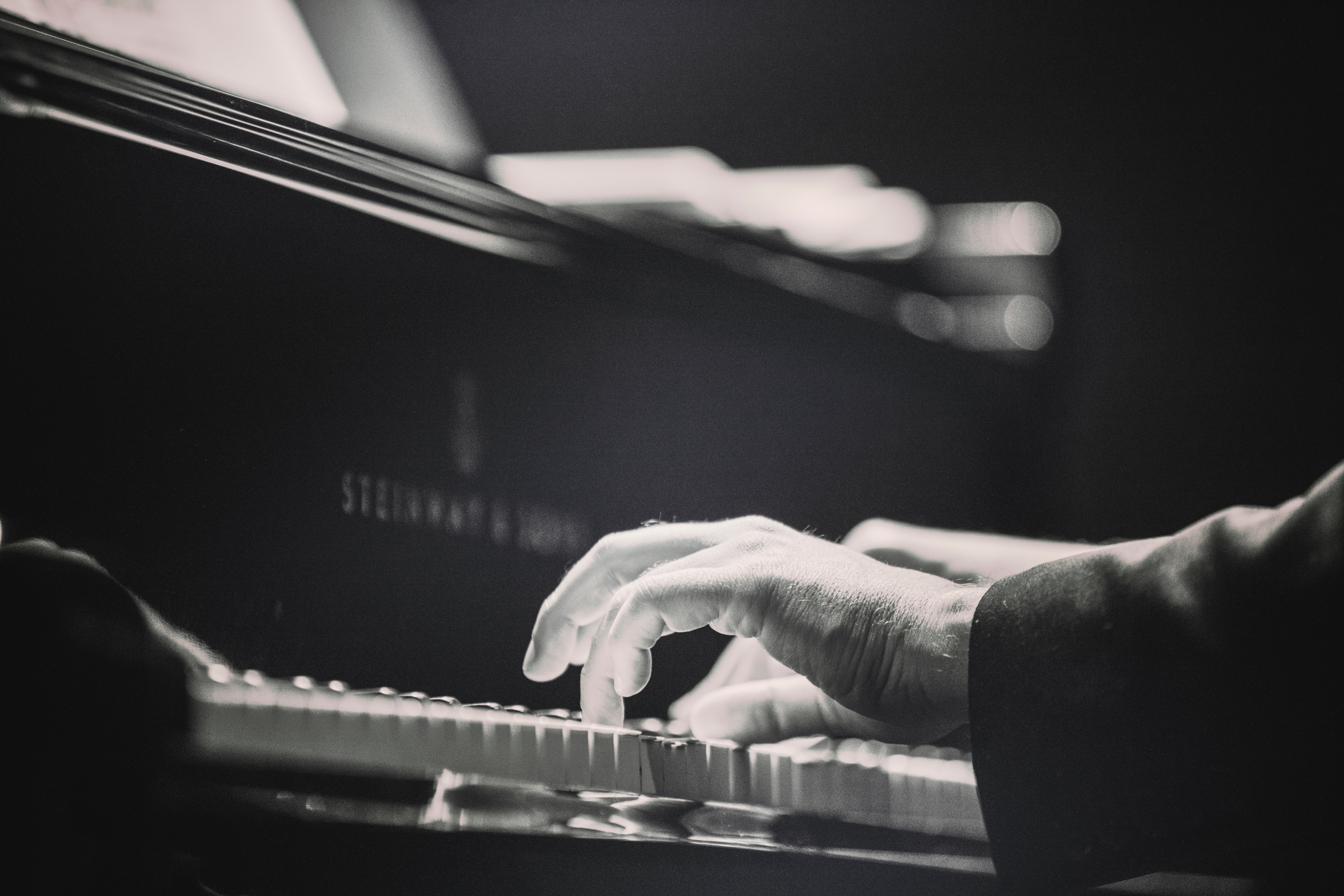 Black and White Image of Old Man Playing Piano on Steinway on Aaron Neuhaus Piano Academy.com