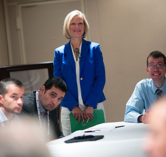 Woman in blue suit teaching a class 