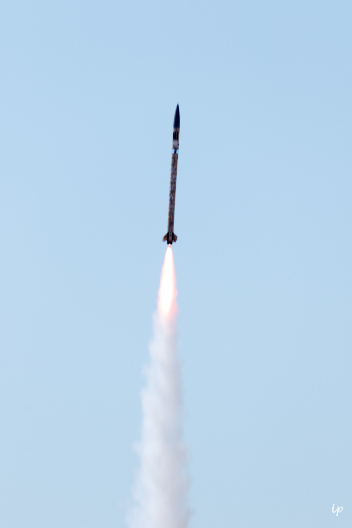 Photo of Cornell Rocketry Team's rocket, Ezra, in flight.