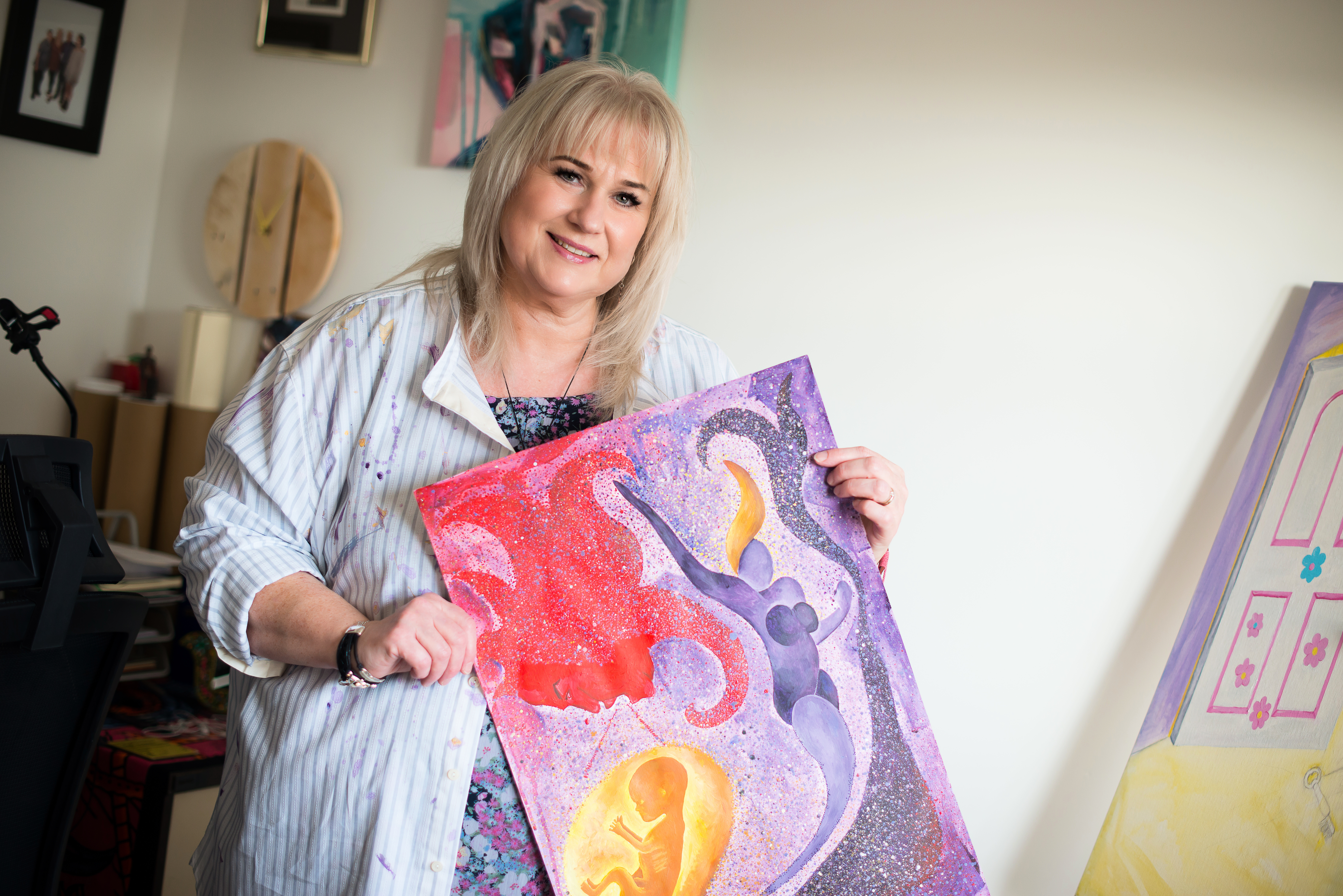 Picture of a woman holding a painting