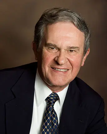 Portrait of Marvin Blickenstaff smiling in a suit