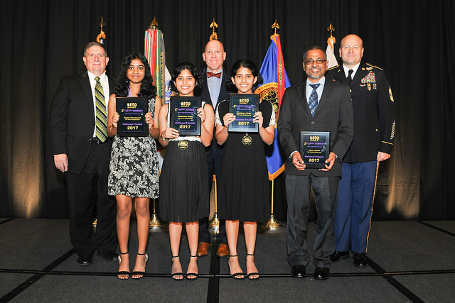 Photograph showing The Three Musketeeretts receiving a $5,000 STEM-In-Action Grant