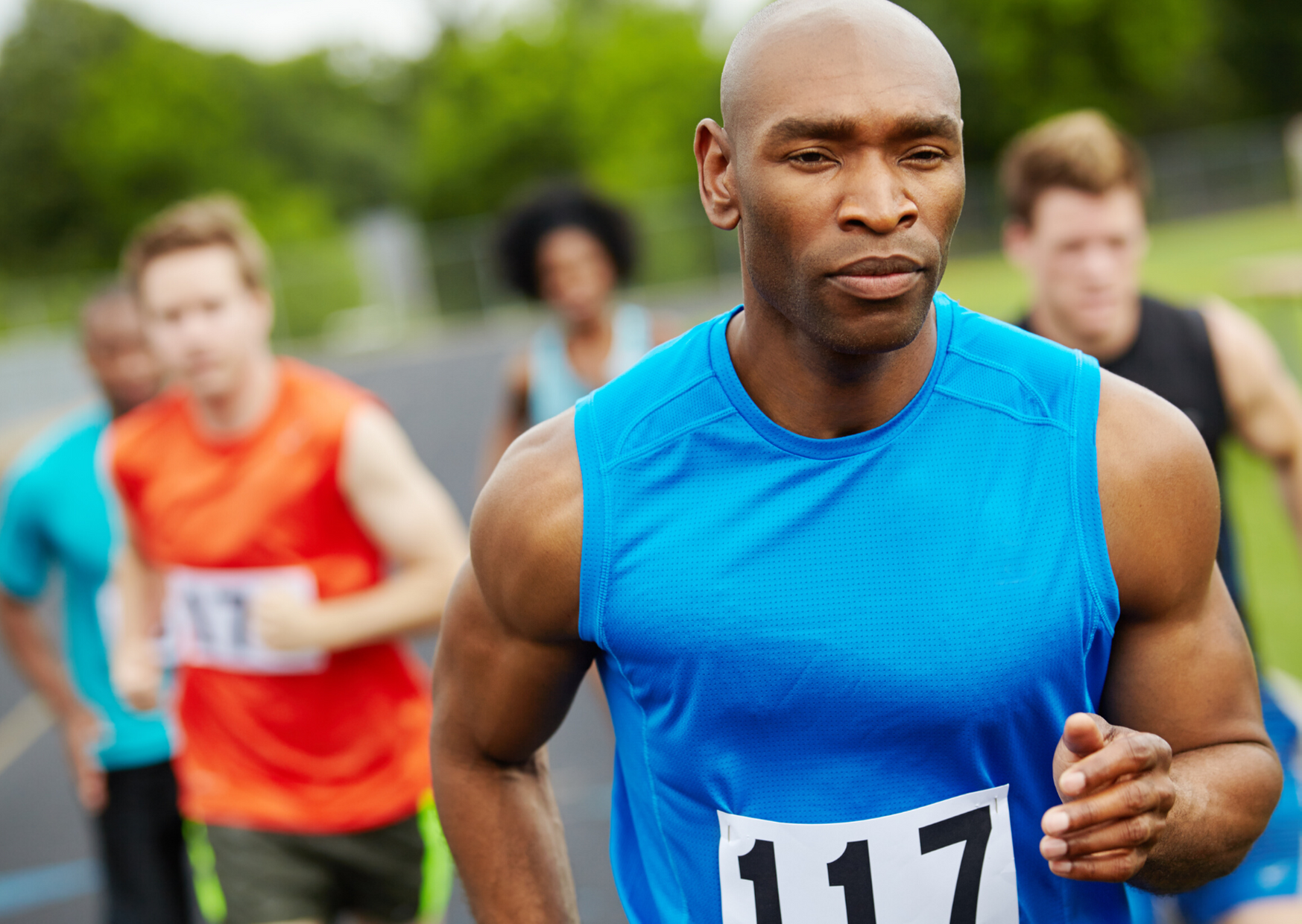 Man running with mouth closed in a race